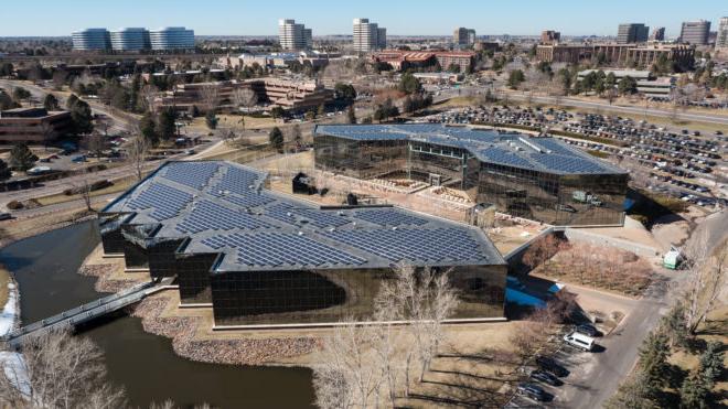 Aerial view of 丑角广场 in Denver, featuring a large solar panel installation on the roof.